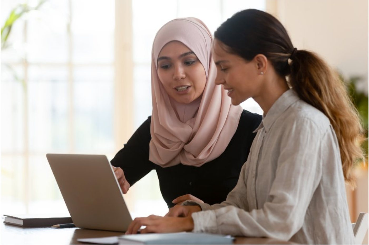 A young person standing confidently with their schoolwork