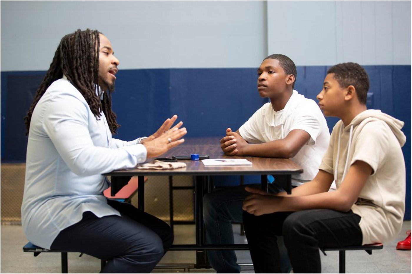 Practitioner in conversation with two young people